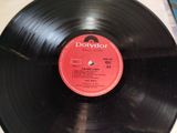 a black record with a red label sitting on a table