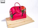 pink louis vuitton handbag sitting on top of a brown paper bag