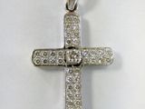 a white gold cross pendant with diamonds on a white background