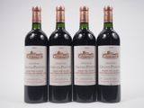 three bottles of red wine sitting next to each other on a white surface