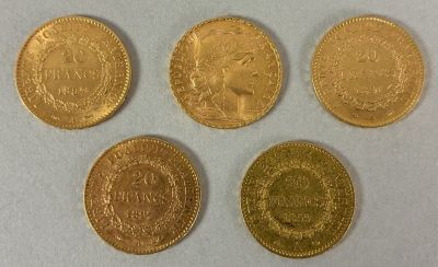 four different types of gold coins on a white surface