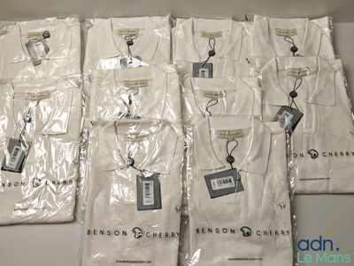 a lot of white shirts that are sitting on a table