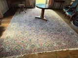 a rug on the floor in a room with a table and chairs