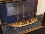 a picture of a model of a ship in a glass case