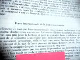 a pink piece of paper on top of an open book