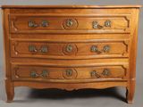 a wooden chest of drawers with ornate carvings and handles