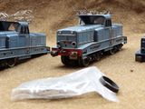 three toy trains sitting next to each other on a table