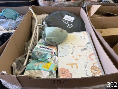 a cardboard box filled with items that include a baby ' s diaper and other items