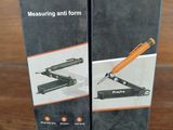 pair of black and orange scissors sitting on top of a wooden table