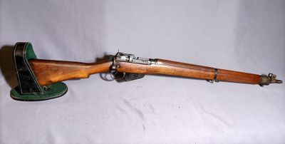 an old wooden rifle with a green hat on a white background