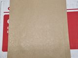 an open brown envelope sitting on top of a white table