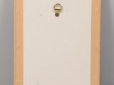 a picture of a picture frame with a ring hanging on it