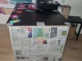 a laptop computer sitting on top of a newspaper box