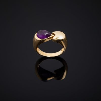 a gold and amethorate ring with a purple stone