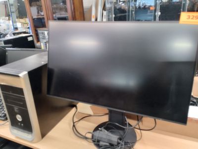 an image of a computer desk with a monitor and a keyboard