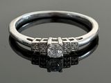 an image of a diamond ring on a black surface