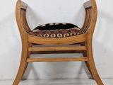 an image of a wooden chair with a black cushion on it