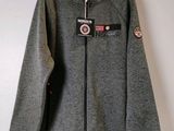 a close up of a grey jacket hanging on a wall