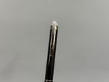 a close up of a pen on a table with a white background