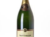 the bottle of champagne is sitting on a white surface