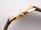 an image of a close up of a watch on a white surface