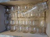 a box full of empty wine glasses and a bottle