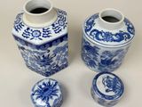 three blue and white vases sitting next to each other