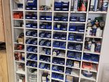 a shelf with many cans and cans of paint on it