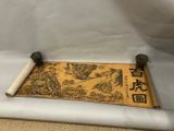 an old scroll with chinese writing on it sitting on a table