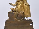 a gold statue of a man and a woman on a cart