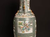 a vase that is sitting on a table in front of a black wall