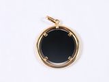 an image of a gold locke with a black stone in the center