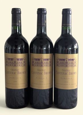 three bottles of wine sitting on top of a table next to each other
