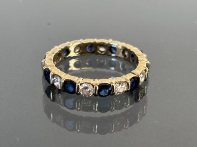an image of a diamond and sapphire ring on a table