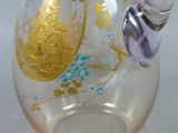 a glass vase with a gold and blue design on it