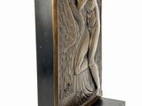 an art deco sculpture of a woman holding a sword on a stand