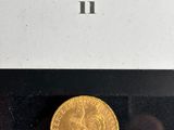 a close up of a gold coin in a box on a table