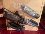 a hair dryer, brush, and comb in a box on the floor