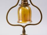 an antique brass table lamp with a bell on a stand