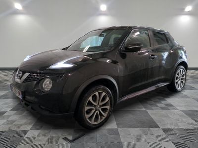 a picture of a black nissan suv parked in a garage