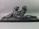 bronze statue of a woman and a child on a body of water