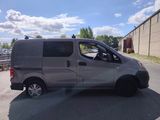 a silver van that is parked on the side of the road