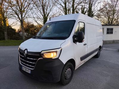 a white van parked in a parking lot with trees in the background
