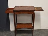 a small wooden table with a drawer on it