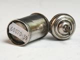 pair of antique silver salt and pepper shakers on a white surface