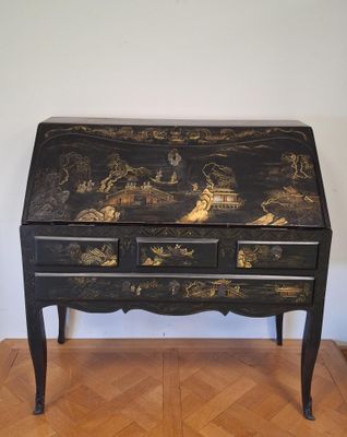 black and gold painted desk with drawers and drawers on top of it