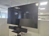 a flat screen tv on a stand in an office