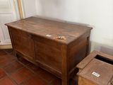 a small wooden chest next to a small wooden box on the floor