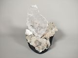 a close up of a piece of rock with a crystal on top