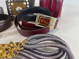 many belts that are sitting on a table together